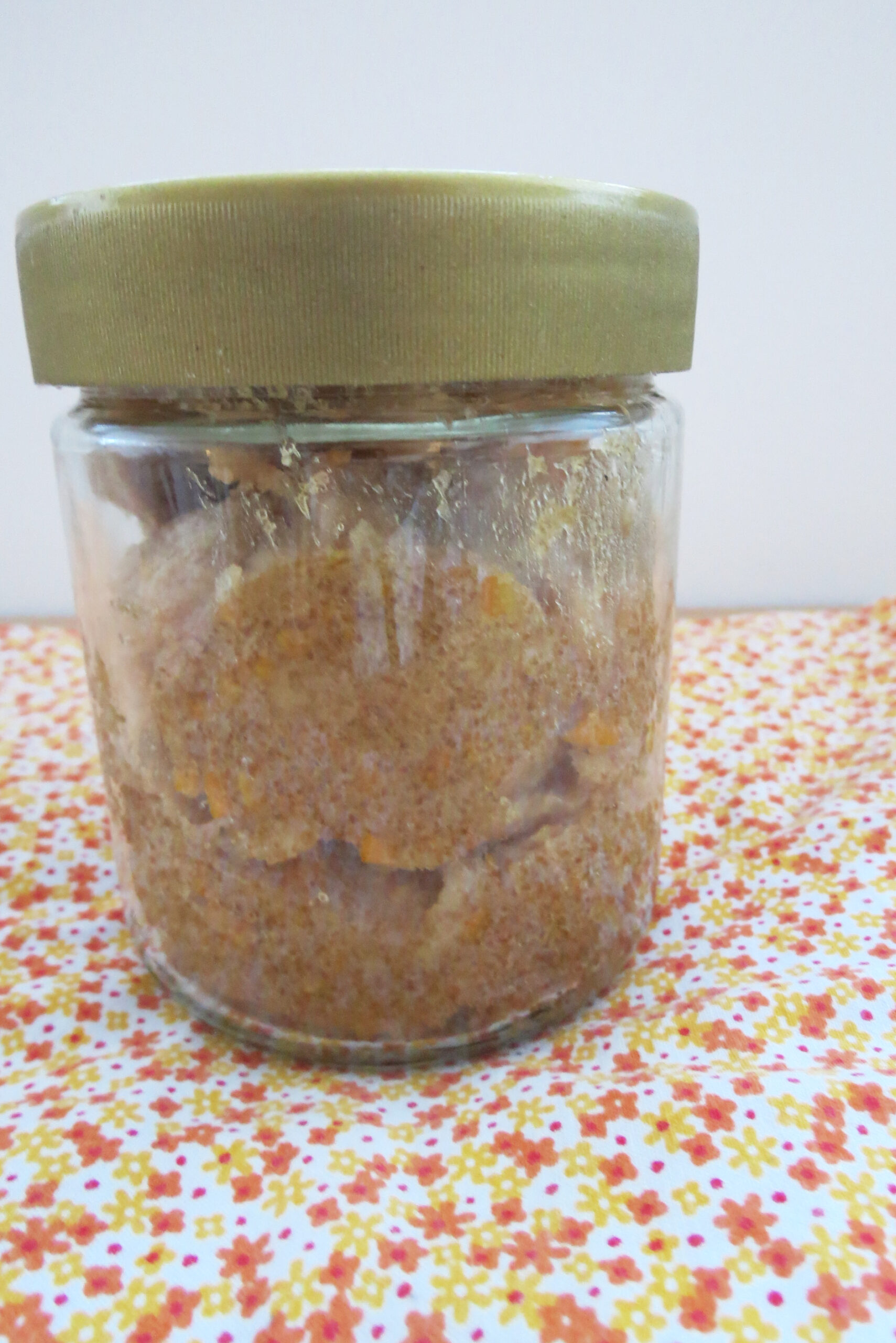 Homemade orange body scrub in a jar
