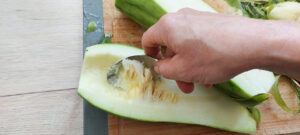 Remove the zucchini seeds with a spoon