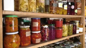 Pantry shelves with different food items in transparent jars