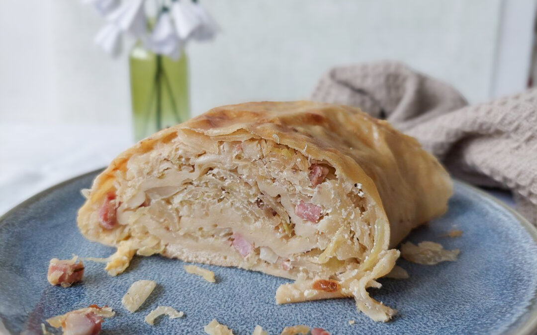 Slice of sauerkraut strudel on a plate