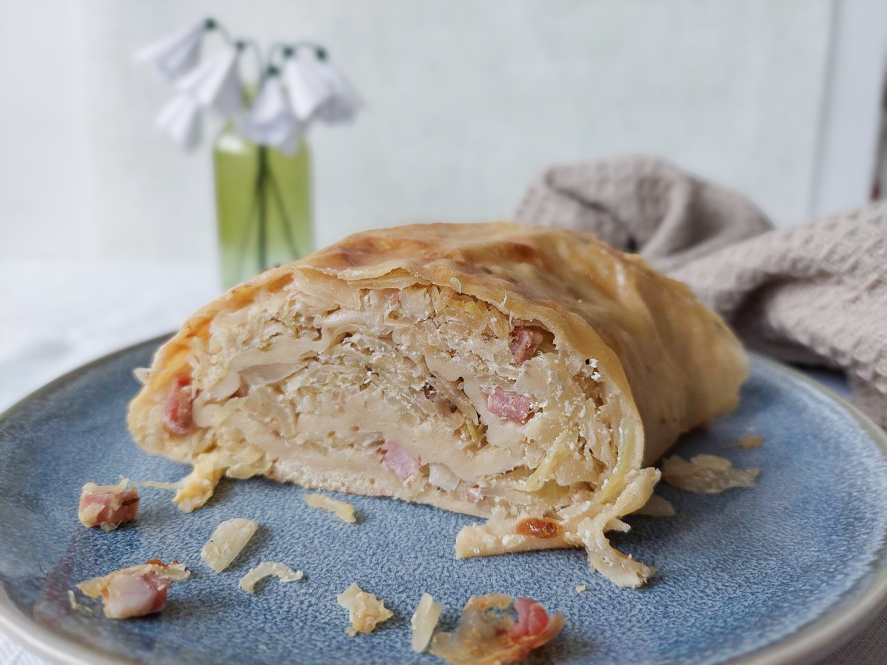 Slice of sauerkraut strudel on a plate