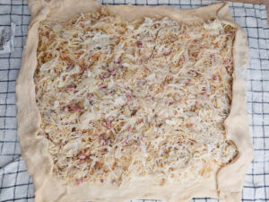 Strudel dough with filling and short edges folded inward