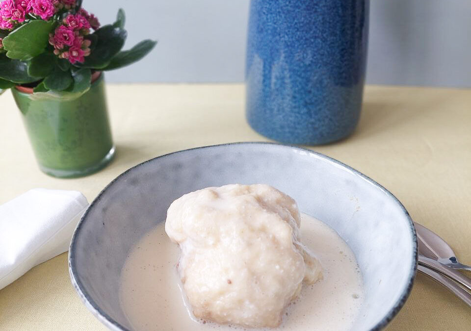 Dampfnudel in a bowl with vanilla sauce