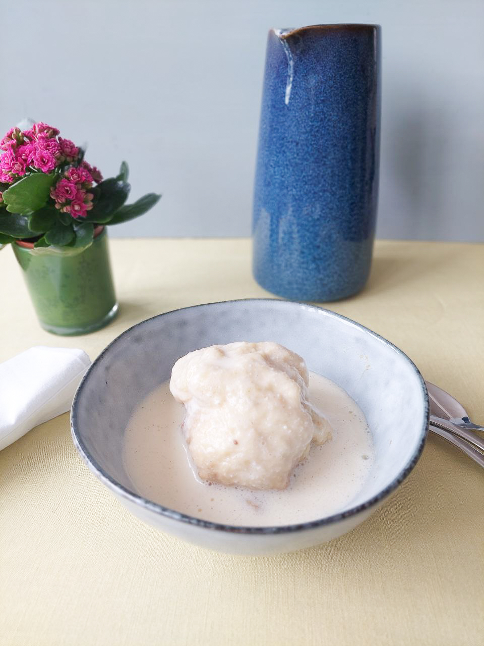 Dampfnudel in a bowl with vanilla sauce