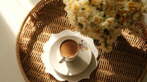 Coffee cup and flowers on a balcony table