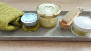 Tablet with homemade hand oil, hand scrub, healing salve, nailbrush and soft towel