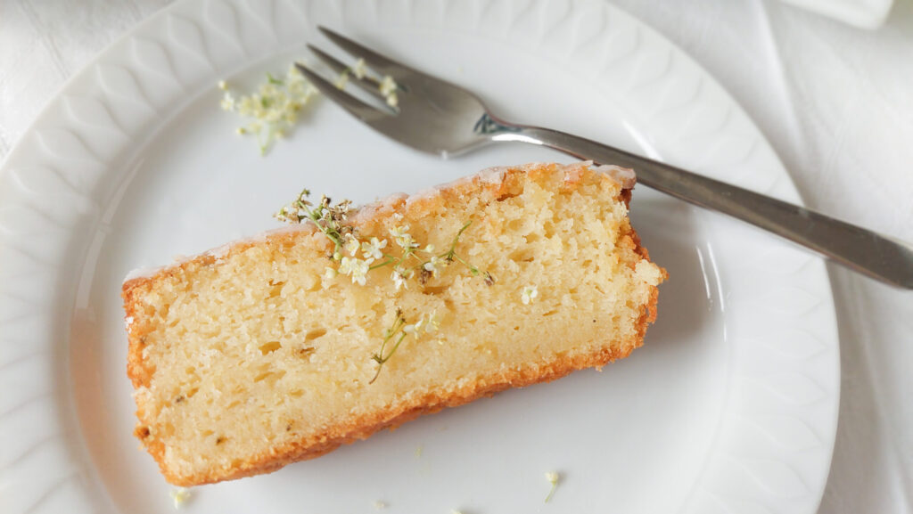 Plate with a piece of elderflower cake and fork