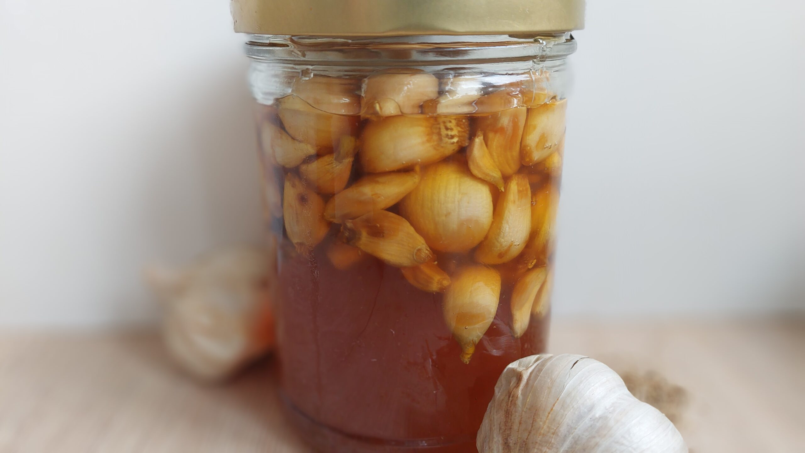 A jar of fermented garlic in honey