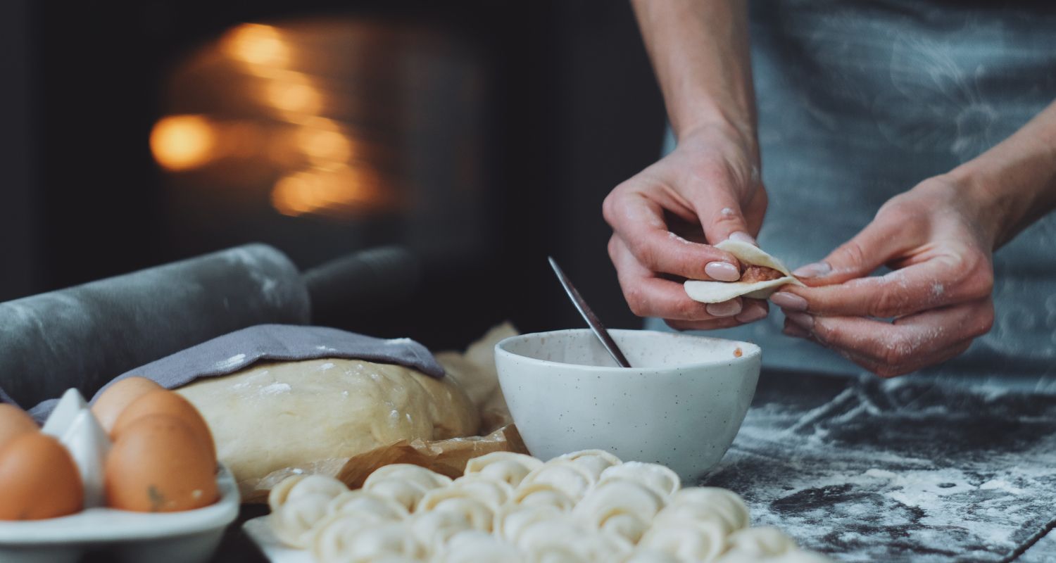 Recipes - Hero Hands forming dough, eggs, and flour in the foreground